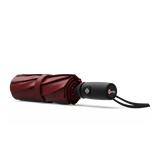 An image of a closed, red colored travel Repel umbrella.