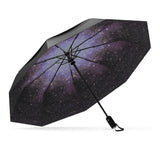 Starry Night windproof umbrella, open and leaning left, with black canopy and starry interior